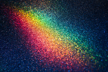 Defocused glitter texture background with rainbow bokeh lights on it