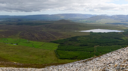 Obraz premium Rock wall, vegetation and stream at Croagh Patrick mountain, Westport, Ireland