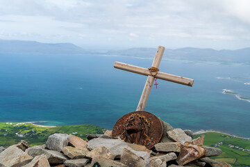 Panoramic, scenic sea and mountain landscape with islands. Holy cross in foreground. View from...
