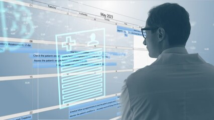 The attending physician compares the data with the patient's observation and treatment algorithm against the background of medical data symbols and huge screen.