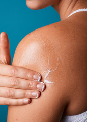 Young woman or girl applying moisturizing lotion cosmetic product cream, self care massage on arm....