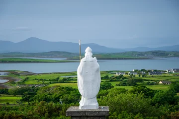 White statue of Saint Patrick at the start of foot path to the peak of Croagh Patrick, county Mayo, Ireland © Marcin
