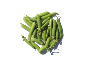 Green Peas pod and peas lie on a white isolated background.	