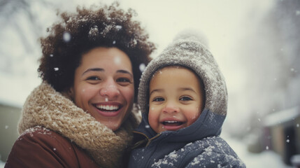 Portrait of a mother and son family enjoying the winter snow during the Christmas season
