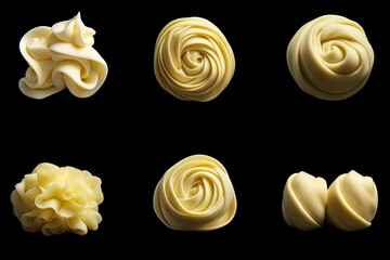 Assorted butter curls or rolls in isolation on a black background