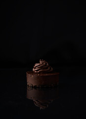 Dark decorated chocolate mousse dessert cake on glass elegant poster