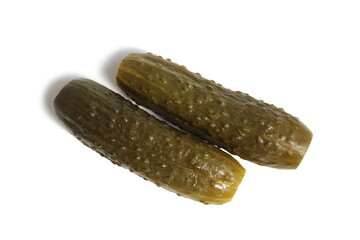 Two pickled cucumbers lie on a white background.