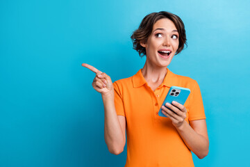 Photo of impressed funky lady wear orange t-shirt chatting apple samsung iphone showing empty space...