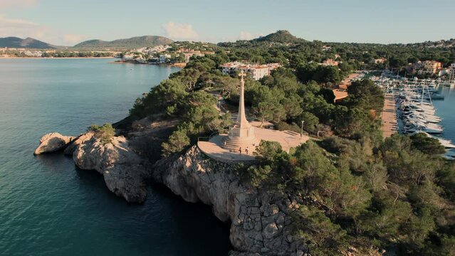 Aerial shot, drone point of view touristic resort, popular travel destination Santa Ponsa town in Baleares, Majorca Island in Spain. Mediterranean Sea view, townscape and religious monument in port
