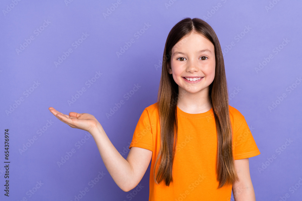 Poster portrait of dream positive smile toothy young schoolgirl kid child hand holding demonstrate object i