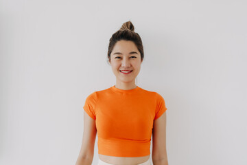 Thai asian woman bun hair wear orange, Smiling  standing and Looking at camera. isolated on white background.