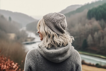 Mature woman with gray hair overlooking winter/fall landscape - obrazy, fototapety, plakaty