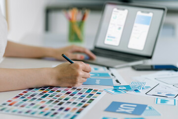 Creative ux designer designing screens for mobile responsive application development with UI UX....
