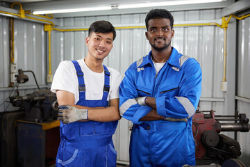 workers or technicians smiling and crossed arms pose in the factory