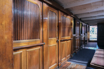 Historic wood paneled lounge, bar or dining room onboard nostalgic windjammer sailing yacht boat...