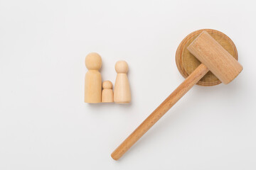 Wooden family figures with judge's gavel on color background,top view
