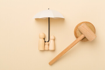 Wooden family figures with judge's gavel on color background,top view