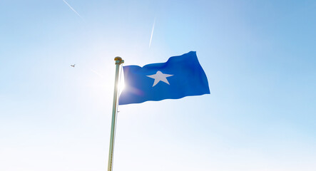 Flag of Somalia waving in the wind, sky and sun background. Somalia Flag. Ultra Hd.