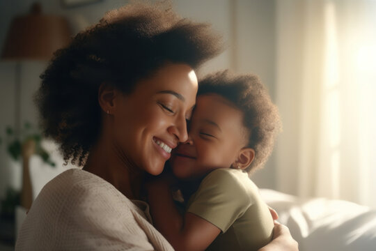 Unconditional Love: A Happy Black African American Mother Shares a Warm Hug with Her Beloved Baby at Home.