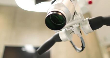 Close-up view of dental microscope indoors in medical clinic without people. Professional equipment with changing magnification and lens in a dental office in a hospital - obrazy, fototapety, plakaty
