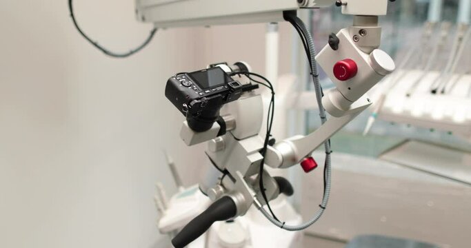 Close-up view of dental microscope indoors in medical clinic without people. Professional equipment with changing magnification and lens in a dental office in a hospital