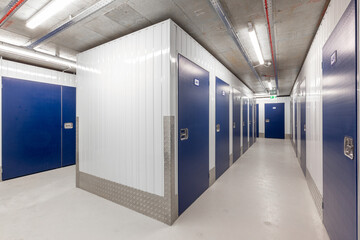 Corridor of self storage unit with blue doors. Rental Storage Units