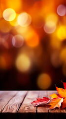 Autumn or Thanksgiving background with rustic wooden planks, leaves and yellow, orange fall colors on the blurred-out trees on the background. Texture with copy space.
