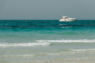 Blue clear sea, yacht, water, waves, clear sky. beach in Saadiyat island, United Arab Emirates. Beautiful seascape.