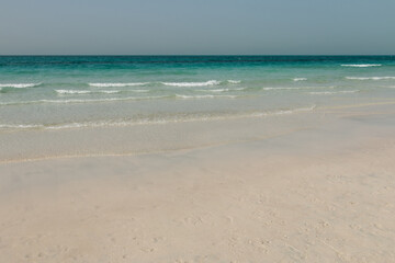 Fototapeta na wymiar Beautiful landscape of white sandy beach with clear turquoise water in Saadiyat island, United Arab Emirates