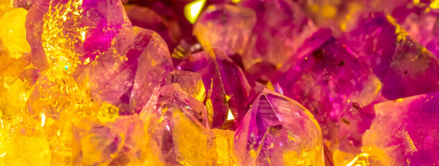 Amethyst pink crystals. Gems. Mineral crystals in the natural environment. Texture of precious and semiprecious stones. Seamless background with copy space colored shiny surface of precious stones.