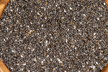 raw chia seeds rich in vitamins and minerals , wooden bowl