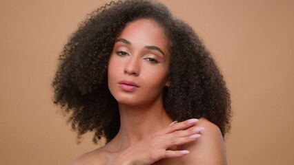 Portrait African American girl ethnic female woman model beauty cosmetic make-up cosmetology skincare beige ad background advertise pampering soft skin moisturizer oil cream organic natural beautiful