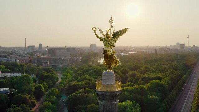 Establishing Aerial view of Berlin Skyline with Victory Column. Goldelse as tourist attraction and viewing platform. German Capital Skyline with Tiergarten park. 4K drone orbit panorama on sunrise