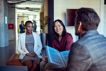 Diverse group of colleagues working on a project together in a modern office