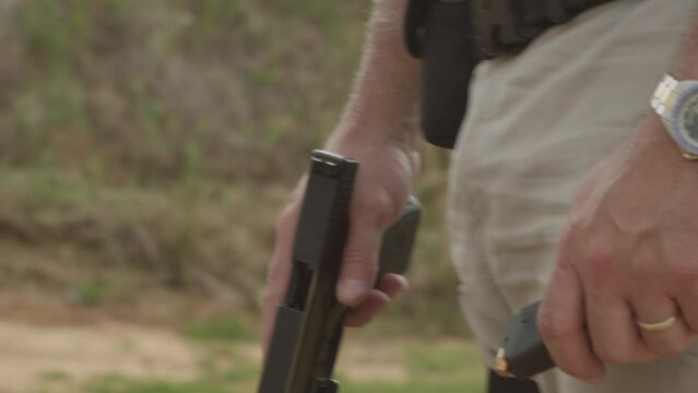 Gun Handgun Raised And Loaded In Slow Motion