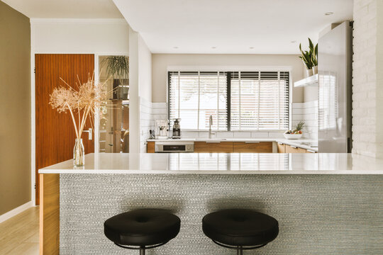 Modern house with open kitchen and stools at counter