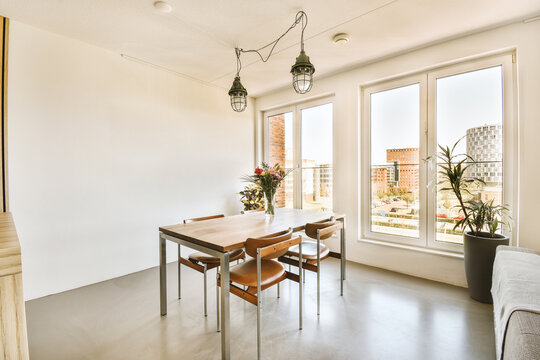 Dining room with long wooden table and chairs by window