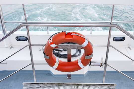 Lifebuoy on metal fence in the ocean