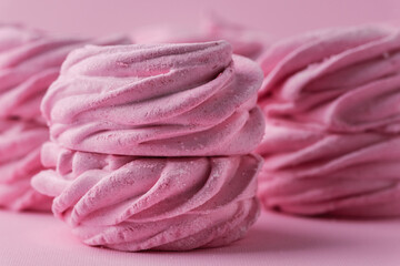 Close up of pink berry homemade marshmallow. Zefir dessert with red currant mousse on the pink...