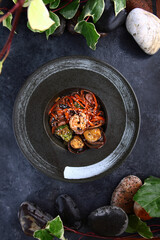Brown soba noodles with seafood and sesame seeds. Broccoli and tiger prawns with noodles.Teriyaki sauce. Vertical photo.Flat lay. Top view. Copy space.