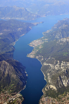 Aerial view of Lake Como in Italy with visible nearby mountains and towns of Valmadrera, Lecco, Abbadia Lariana, Mandello del Lario, Lierna, and Bellagio