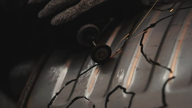 Sparks from dremel tool cutting metal, spark close-up from drilling engraving work in a workshop