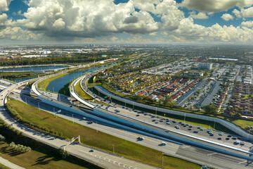 Aerial view of american freeway intersection with fast driving cars and trucks in Miami, Florida....