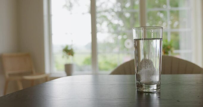 Glass of water with fizzy tablet