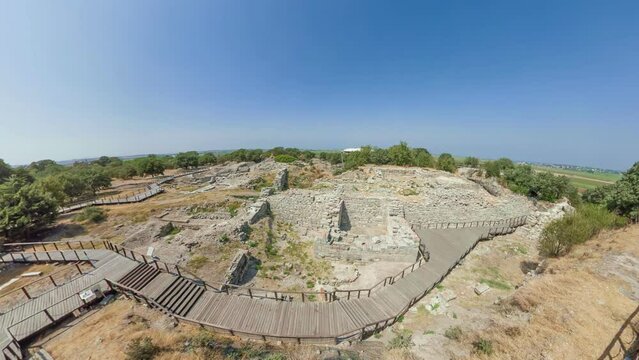 Visitors of Troy explore ruins, including iconic walls and famous Wooden Horse, delving into timeless tales of the Trojan War. A journey in ancient history of Turkey where myth and reality converge.