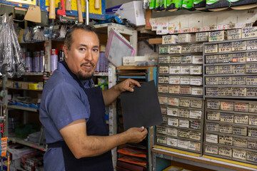Adult  entrepreneur man with apron in her business,