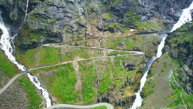 Drone Norway. Car drive on curvy canyon Trollstigen road. Famous scenic drive, Norwegian landmark popular tourism destination. Norway in summer, 4k.  