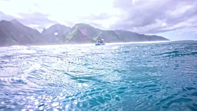 Underwater Tahiti 4k. Ocean clear water with mountains background. Teahupoo famous surfing destination in French Polynesia. Adventure travel. Slow motion.