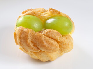 Tokyo, Japan - September 29, 2023: Closeup of cream puff with topping grapes
