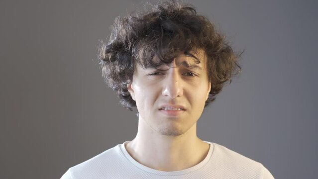 Young man giving subliminal message.